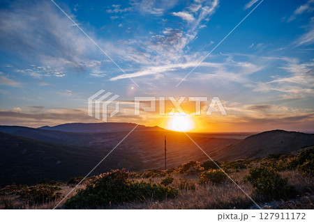 Breathtaking sunset illuminating Crimean mountains and valley 127911172