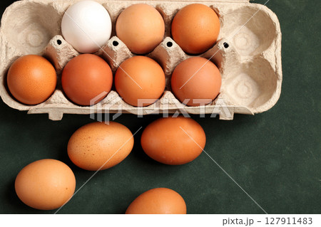 Close-up view of raw chicken eggs in box, egg white, egg brown Close-up view of raw chicken eggs in box, egg white, egg brown 127911483
