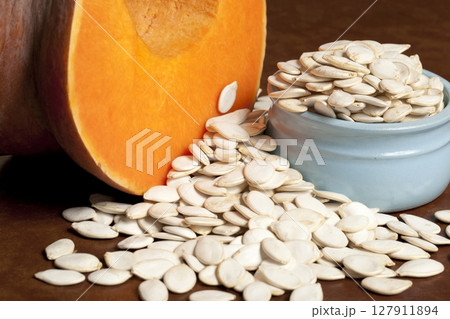 Pumpkin and pumpkin seed in a blue Cup Pumpkin and pumpkin seed in a blue Cup 127911894