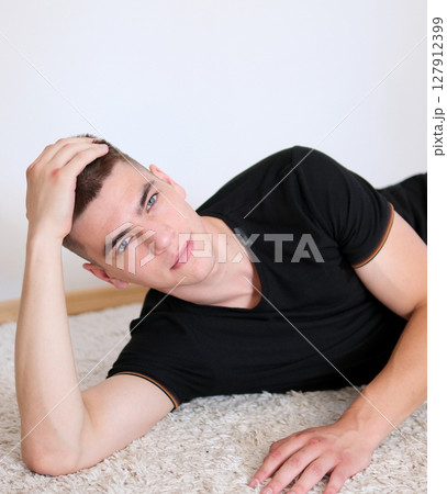 Handsome student working at startup project at home Handsome student working at startup project at home 127912399