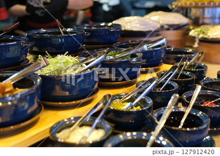 Lumber plate with assorted aromatic spiced falling on table and spilling mix on table 127912420