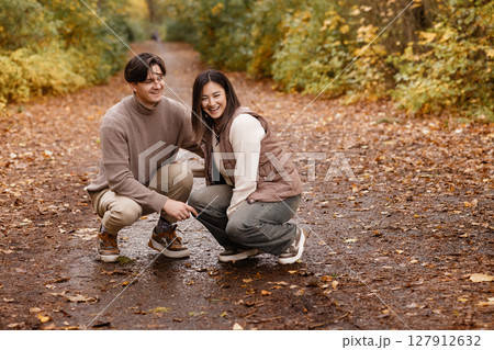 Happy Couple Walking Dog on Forest Trail 127912632