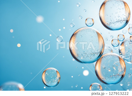 vibrant and luminous background featuring various transparent bubbles of different sizes floating in clear blue liquid with sparkling highlights 127913222