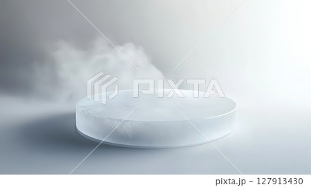 frosty circular ice podium is displayed in minimalistic setting with soft misty effect, creating cool and serene atmosphere. smooth surface and icy texture enhance visual appeal. 127913430