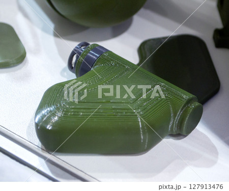 Mina Petal printed on 3D printer. Anti-personnel explosive mine created on 3D printer from molten plastic. Prototype of ammunition printed on 3D printer. Innovation modern new 3d printing technology Mina Petal printed on 3D printer. Anti-personnel explosive mine created on 3D printer from molten plastic. Prototype of ammunition printed on 3D printer. Innovation modern new 3d printing technology 127913476