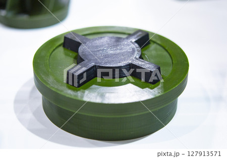 Anti-personnel high explosive mine printed on 3D printer. Mine created on 3D printer from molten plastic. Prototype of ammunition printed on 3D printer. Innovation modern new 3d printing technology Anti-personnel high explosive mine printed on 3D printer. Mine created on 3D printer from molten plastic. Prototype of ammunition printed on 3D printer. Innovation modern new 3d printing technology 127913571