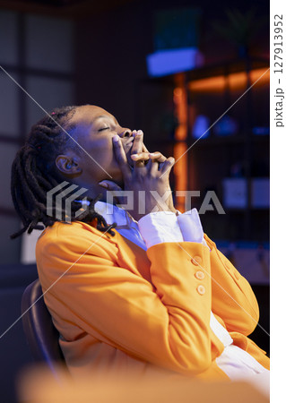 Stressed student feeling anxious, afraid of being unable to finish daunting homework tasks. Tense african american gen Z teenager suffering burnout while working on school project 127913952