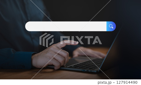 Adult man using a laptop searching on the internet. SEO technology networking, representing online browsing, information seeking, and digital search technology in a modern workspace. Adult man using a laptop searching on the internet. SEO technology networking, representing online browsing, information seeking, and digital search technology in a modern workspace. 127914490