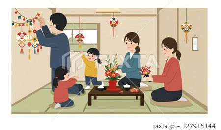 飾り付けをしながら、家族でパーティーの準備を進める 127915144
