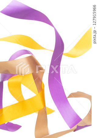 Yellow Gold Purple ribbon long straight fly in air with curve roll shiny. Yellow Golden Purple ribbon for present gift birthday party to wrap around decorate and make of textile cloth long straight. 127915966