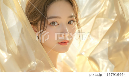 金色のベールのような柔らかい布と美しい若い女性のビューティーイメージ 金色のベールのような柔らかい布と美しい若い女性のビューティーイメージ 127916464