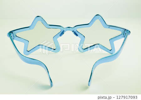 blue star shape of glasses on old sepia background 127917093
