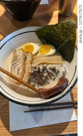 Authentic and Delicious Japanese Ramen Noodle Soup in White Bowl on Wooden Table, Food Photography 127917872