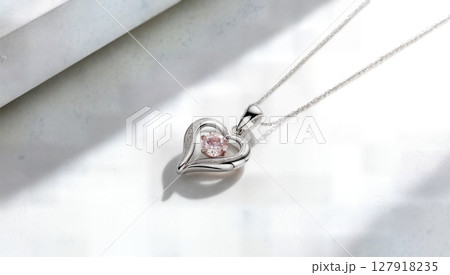 Elegant Silver Heart Necklace with Pink Gemstone Pendant on White Background. Jewelry Fashion 127918235