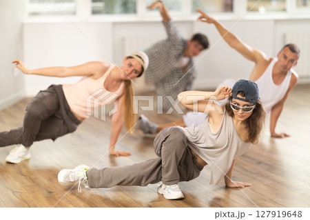 Group of dancers having break dance training at dance studio Group of dancers having break dance training at dance studio 127919648