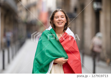Portrait of woman with Italy flag on street of summer city Portrait of woman with Italy flag on street of summer city 127919713