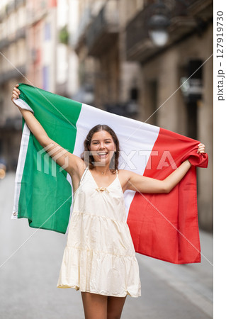 Young woman with Italian flag on city street Young woman with Italian flag on city street 127919730
