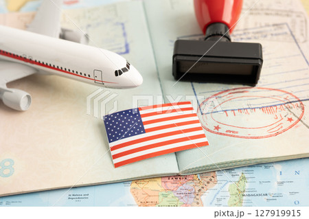 Approved Stamp visa and passport with US flag document to immigration at airport in country. Approved Stamp visa and passport with US flag document to immigration at airport in country. 127919915