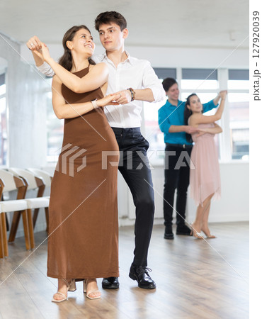 During rehearsal, guy and girl participants of dance workshop perform figure waltz 127920039