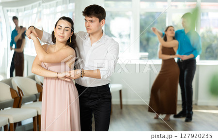 During rehearsal, guy and girl participants of dance workshop perform social pair dance 127920235