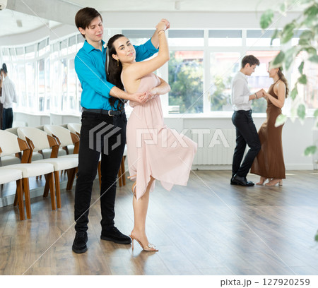 Couple young woman and man dancing latin dances Couple young woman and man dancing latin dances 127920259