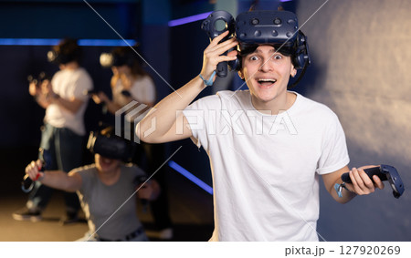 Portrait of young man with a very surprised look, who took off her virtual reality glasses 127920269
