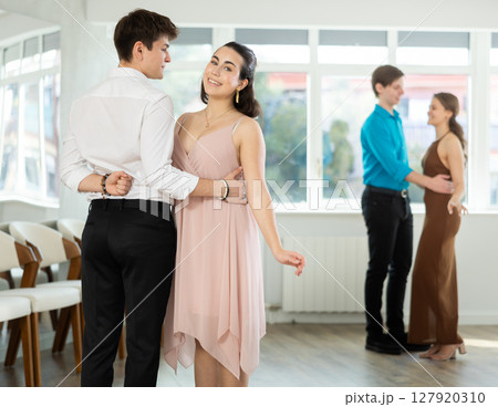 Young brunette dancing waltz with male partner in choreography studio 127920310