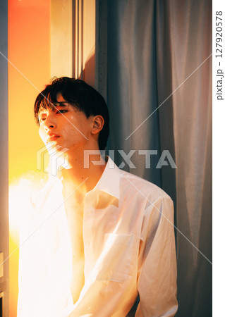 韓国風若手ビジネスマン 夕暮れ光の白シャツポートレート 127920578
