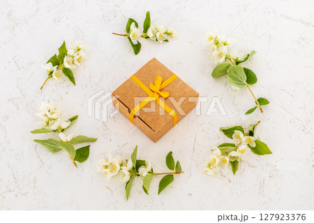 Gift box with flowers on the white background. 127923376