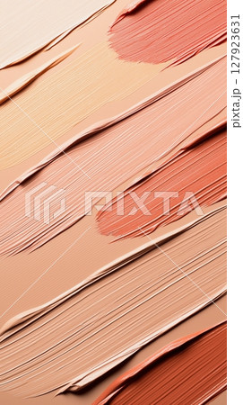 Colorful brushstrokes of creamy natural and peach tone foundation textures 127923631