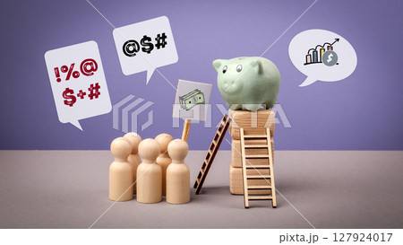 Economic Inequality Concept with Wooden Figures, Piggy Bank, and Protest Symbols Economic Inequality Concept with Wooden Figures, Piggy Bank, and Protest Symbols 127924017