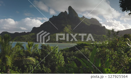 Aerial view of the iconic mount Otemanu dominating the landscape of Bora Bora, surrounded by lush vegetation and tranquil turquoise waters, a tropical paradise in French Polynesia Aerial view of the iconic mount Otemanu dominating the landscape of Bora Bora, surrounded by lush vegetation and tranquil turquoise waters, a tropical paradise in French Polynesia 127925564