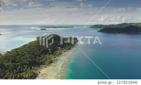 Stunning aerial drone footage captures the beauty of Bora Bora's lagoon, showcasing crystal-clear turquoise waters, vibrant coral reefs, and lush tropical islands under a cloudy sky Stunning aerial drone footage captures the beauty of Bora Bora's lagoon, showcasing crystal-clear turquoise waters, vibrant coral reefs, and lush tropical islands under a cloudy sky 127925646