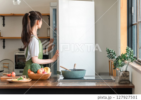 料理,自炊,冷蔵庫から食材を取り出す中高年の女性 127927501
