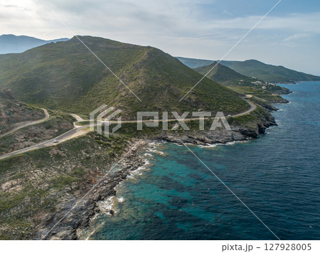 Aerial view car Roadtrip Winding road along rocky coast of Cap Corse peninsula on Corsica island France 127928005