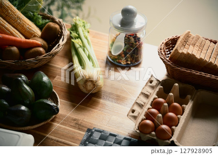 Healthy ingredients arranged on a wooden table for meal preparation 127928905