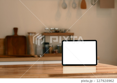 Digital tablet with blank screen on wooden kitchen counter Digital tablet with blank screen on wooden kitchen counter 127928962