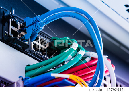 Fiber Optic cables connected to optic ports, network cables conn 127929134