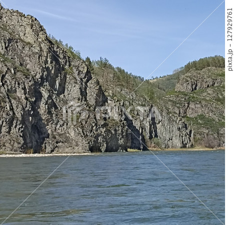 Majestic Mountain Landscape with River, Rocks, and Lush Greenery, Perfect for Outdoor Adventures Majestic Mountain Landscape with River, Rocks, and Lush Greenery, Perfect for Outdoor Adventures 127929761
