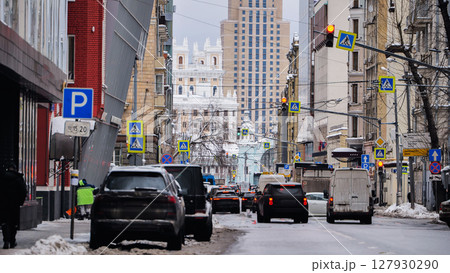 Cars driving on snowy street in Moscow city center Cars driving on snowy street in Moscow city center 127930290