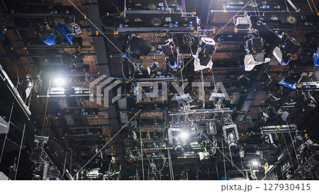 Lighting equipment hanging from ceiling in television studio Lighting equipment hanging from ceiling in television studio 127930415
