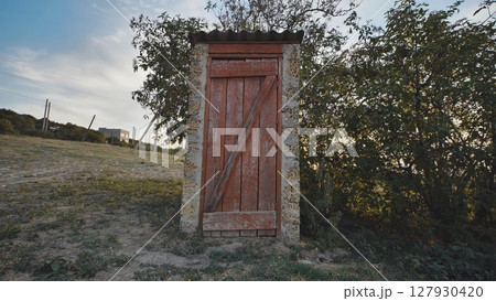 Village restroom in the evening at sunset. 127930420