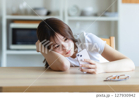 スマとフォンを見つめる若い女性 スマとフォンを見つめる若い女性 127930942