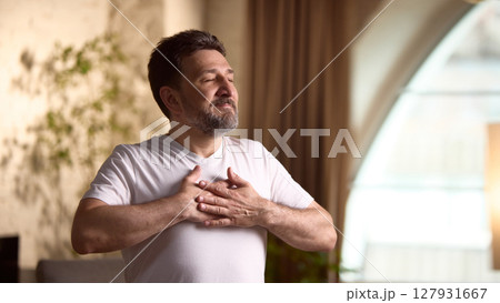 Lifestyle and wellness. Middle aged man practicing mindfulness exercises, relaxed environment 127931667