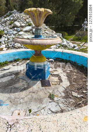 Weathered stone fountain in neglected park area in Kyrgyzstan 127931864