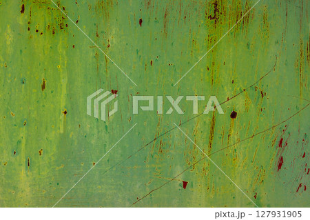 Rusty green metal surface with scratches in urban industrial setting 127931905
