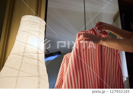 Delicate Dressing Preparing an Elegant Outfit in Soft, Cozy Lighting for Daily Wear and Style 127932185