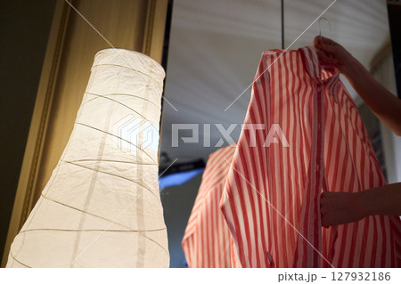 Delicate Dressing Preparing an Elegant Outfit in Soft, Cozy Lighting for Daily Wear and Style 127932186