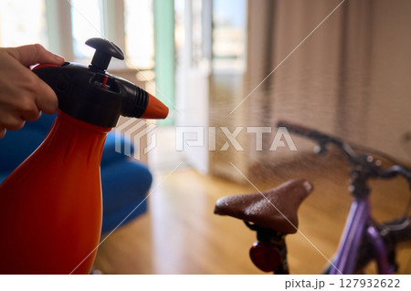 Engaging in Bicycle Cleaning with a Convenient Spray Bottle in a Cozy Environment Space 127932622
