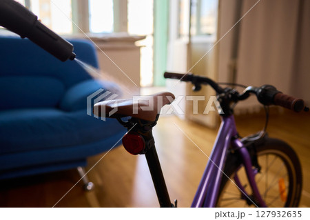 Effectively Cleaning a Bicycle Using a Vacuum Cleaner in a Contemporary Living Room Space 127932635